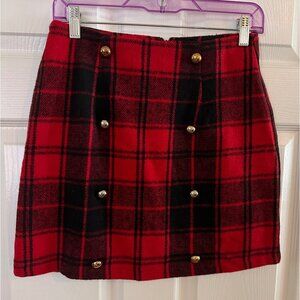 Red and black plaid skirt with gold buttons